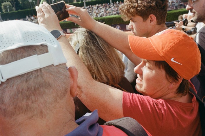 Fans attempt to take phone pictures of their heroes